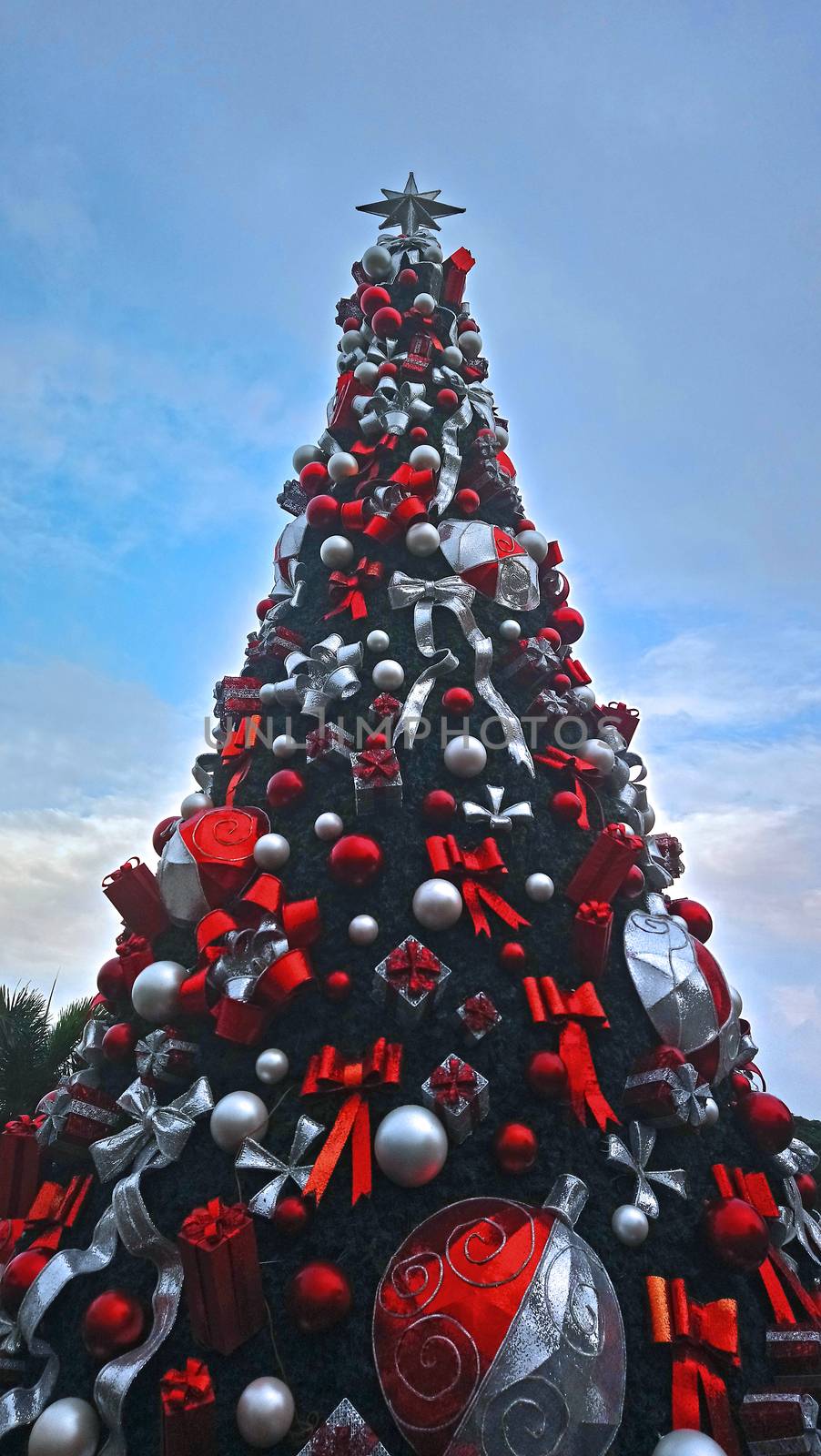 Christmas ball, gift and ribbon decorations attached to Christmas tree