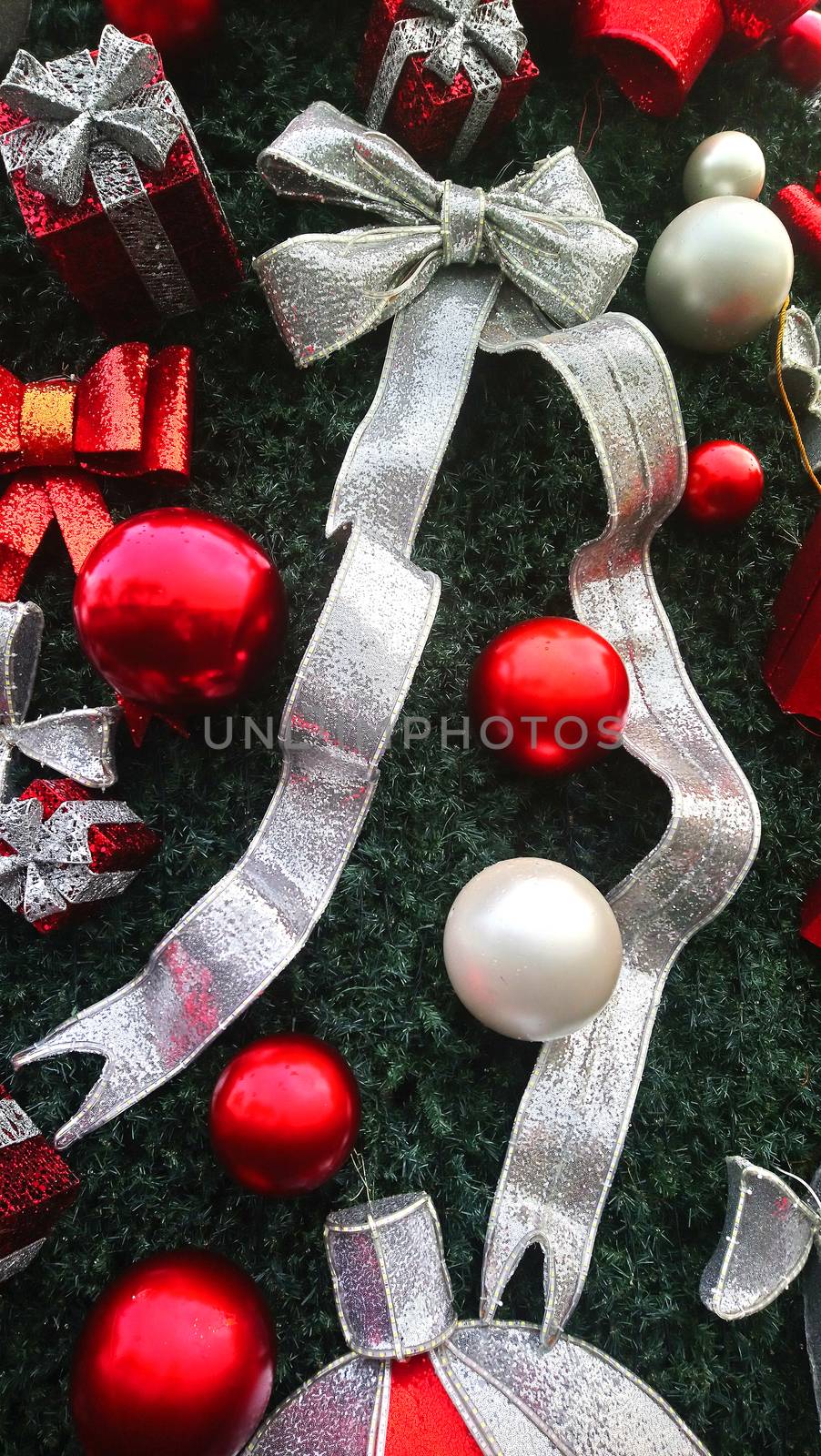 Christmas ball, gift and ribbon decorations attached to Christmas tree