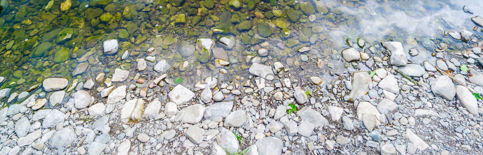 Horizontal panorama background of pebbles and river edge by paddythegolfer