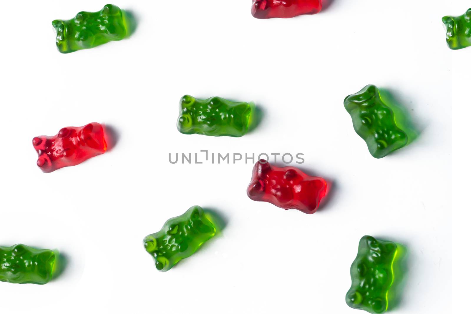 Red and green jelly bears candy on a white background.