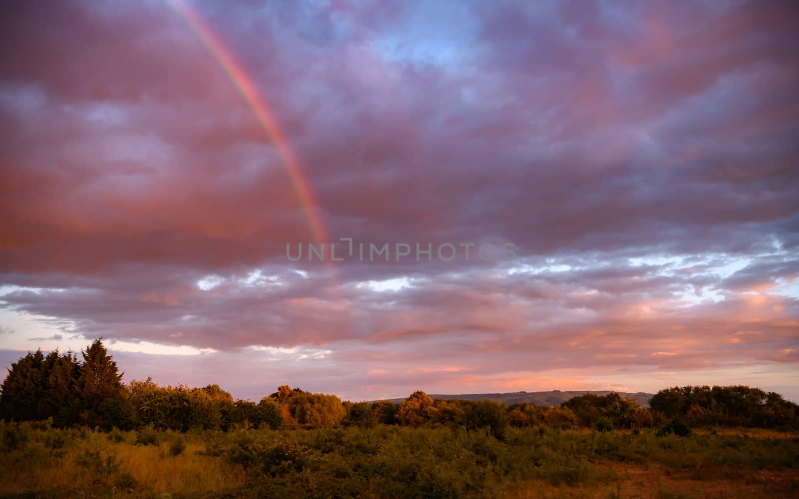 Rainbow sunset landscape in rural England