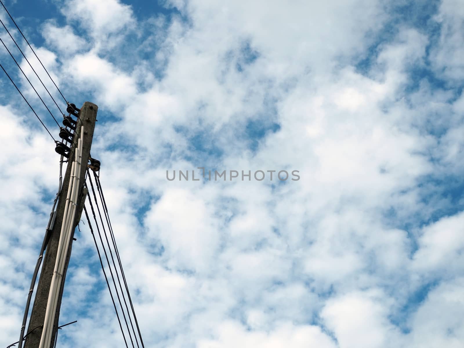Electric pole and electric wire On the background is an empty blue sky.
Minimal concept