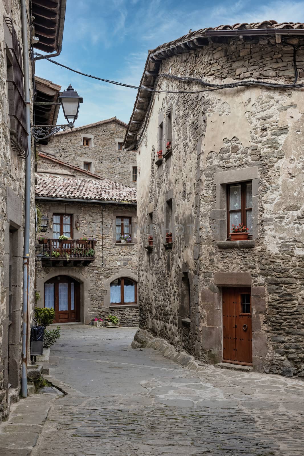 Streets of medieval village of Rupit, Catalonia of Spain by Digoarpi