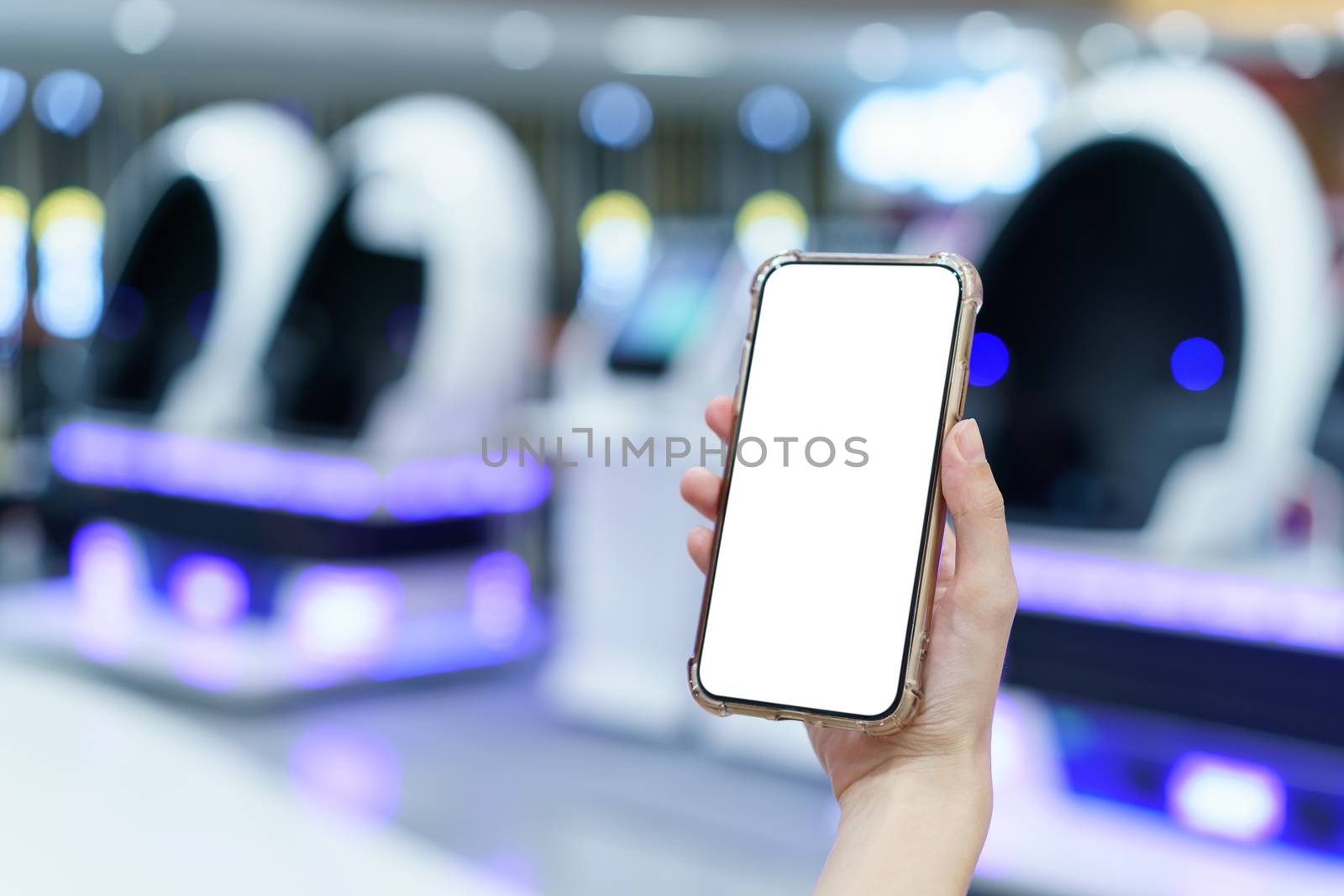 Mockup, hands holding blank white screen mobile phone in blurred game center, digital payment concept