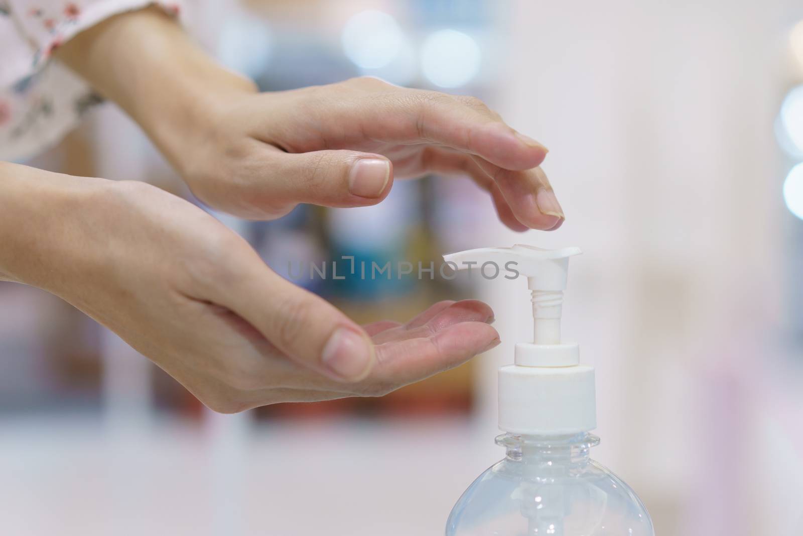 Woman hand press sanitizer bottle to clean her hand. hygiene prevention of coronavirus (Covid-19) virus outbreak.