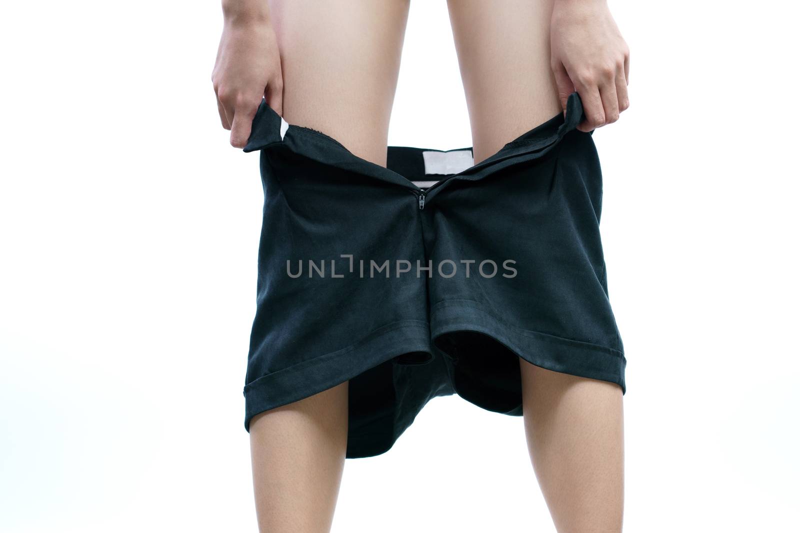 Woman wearing or taking off black shorts pant.