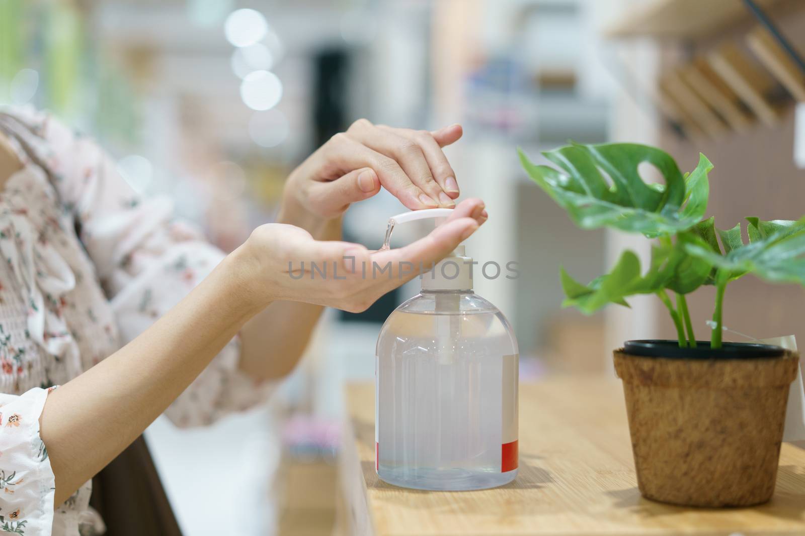 Woman hand press sanitizer bottle to clean her hand. hygiene prevention of coronavirus (Covid-19) virus outbreak.