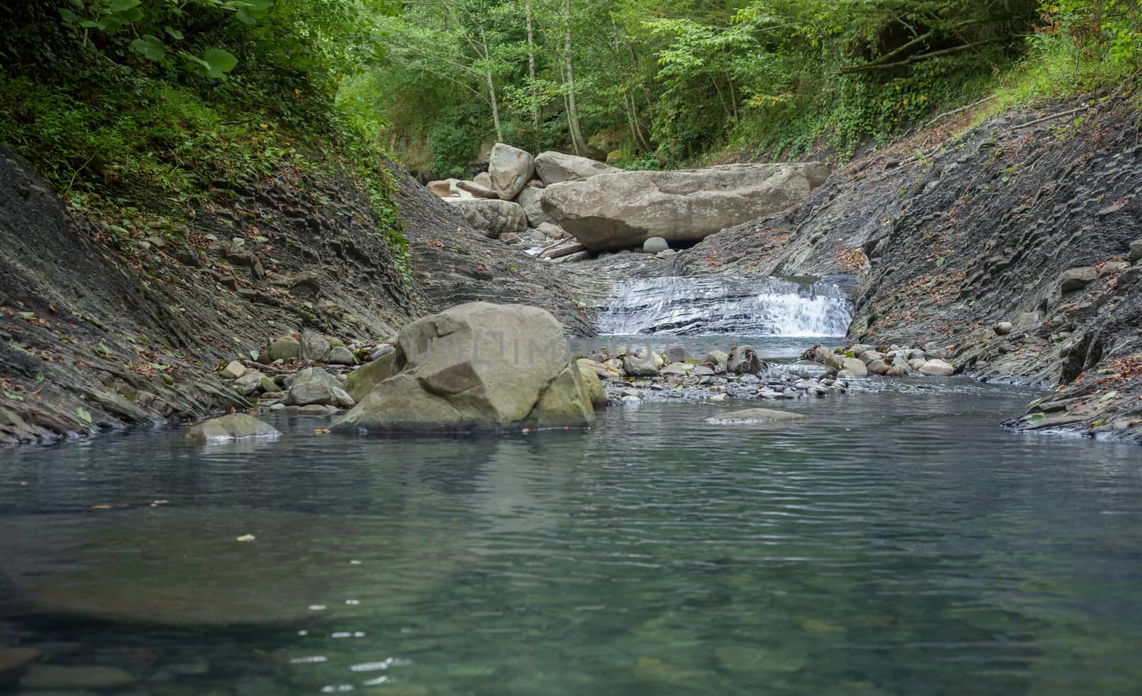 Mountain river in the stone bed at summer