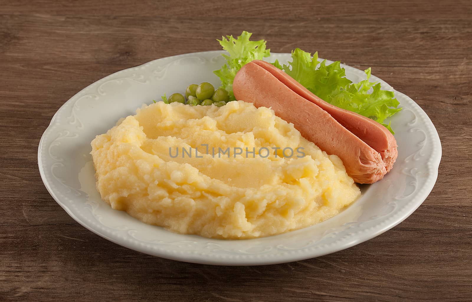 Mashed potatoes with green lettuce, peas and small sausage by Angorius