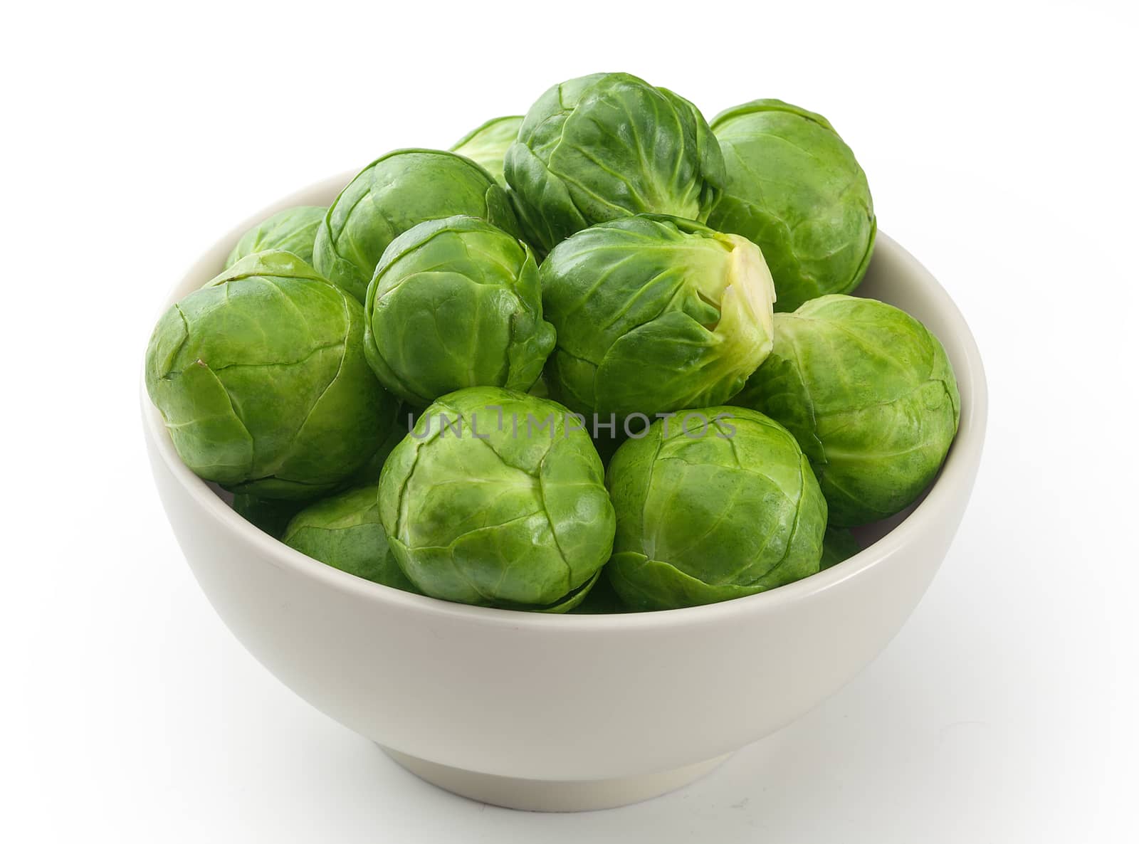 Handful of fresh green brussels sprouts in the bowl