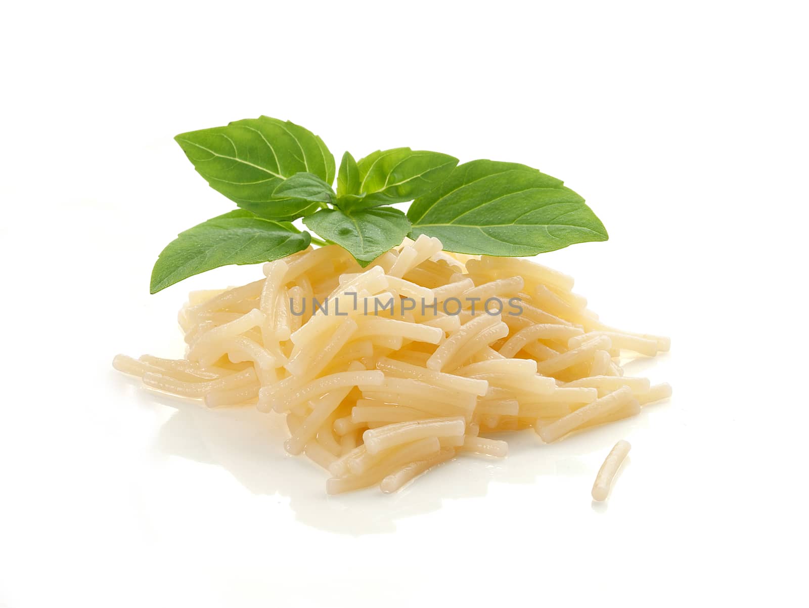 Isolated boiled vermicelli with fresh green basil on the white plate