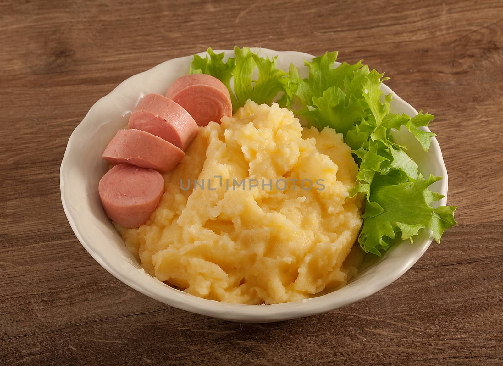 Mashed potatoes with green lettuce and small sausage by Angorius