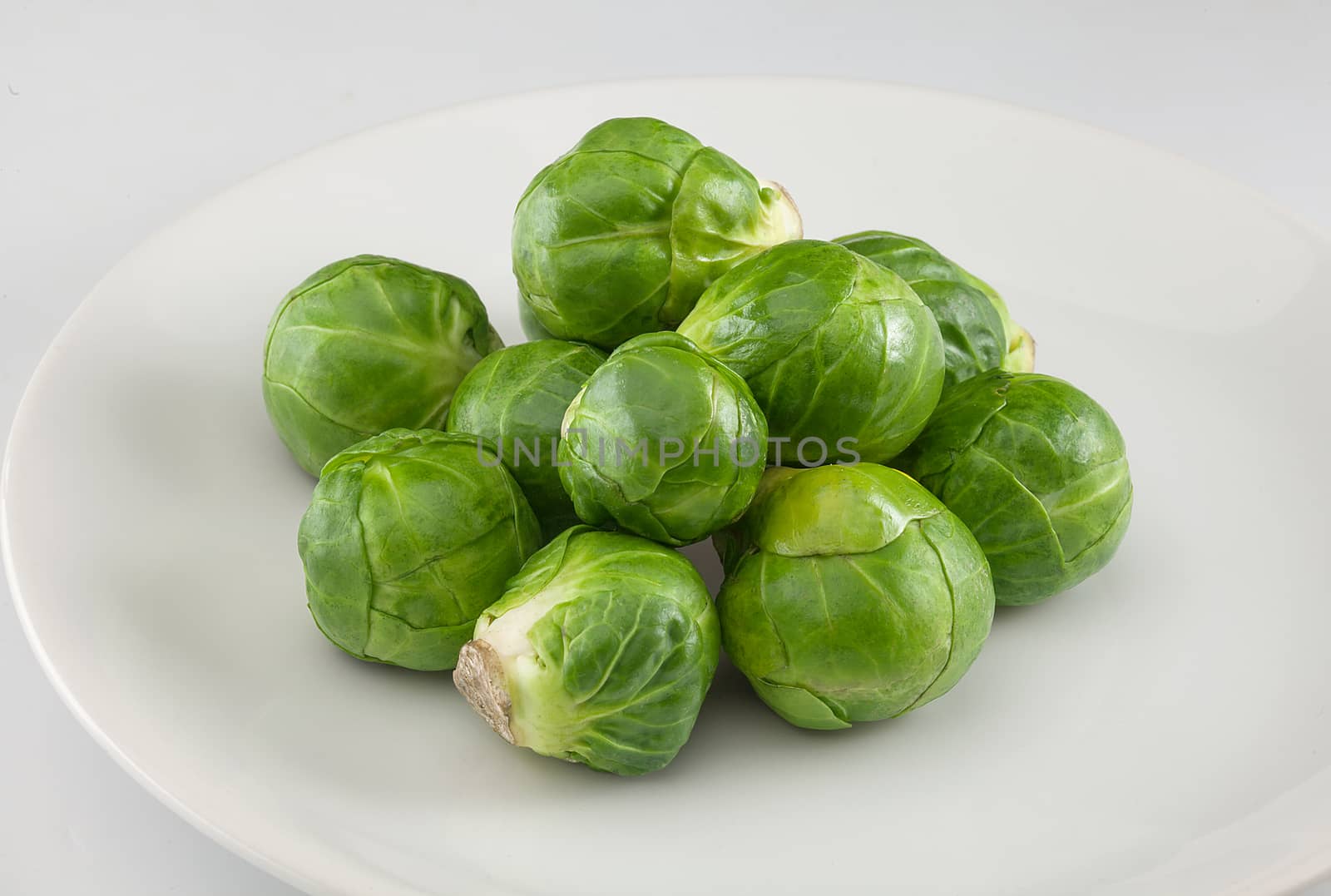 Handful of fresh green brussels sprouts on the plate