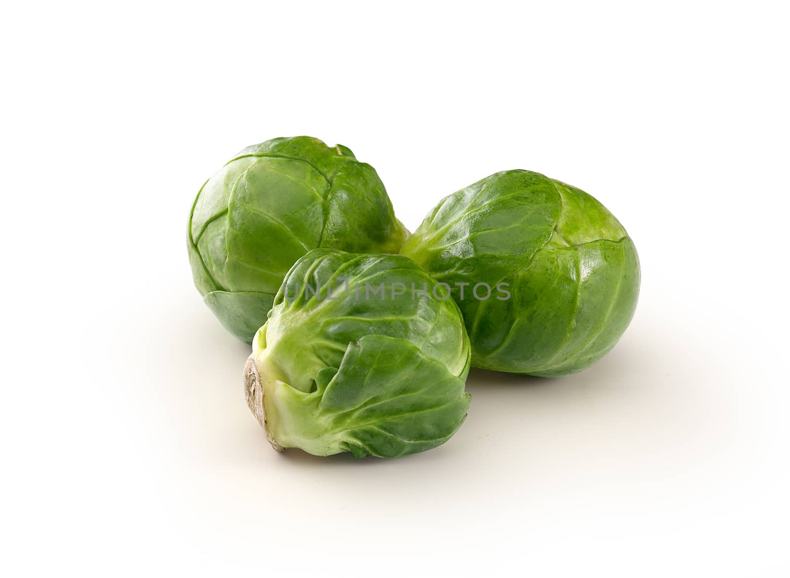 Handful of fresh green brussels sprouts on the white