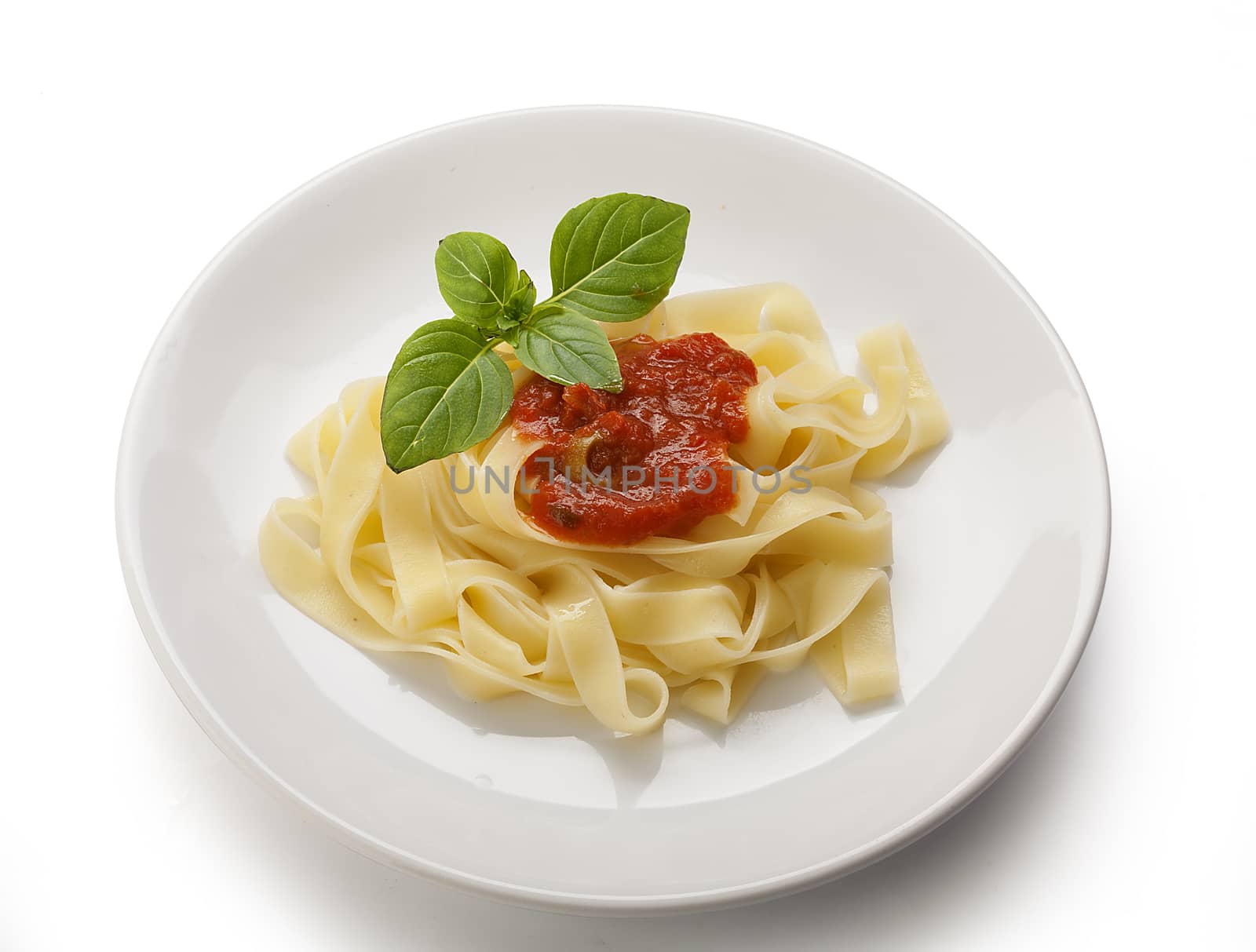 Boiled noodle nest with green basil on the plate