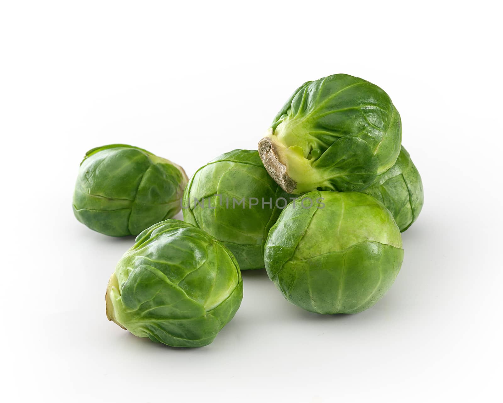 Handful of fresh green brussels sprouts on the white