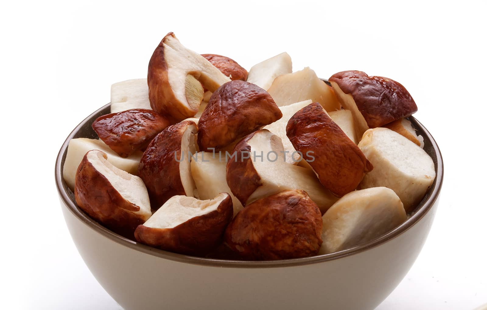 Sliсed pieces of white mushrooms in the white bowl