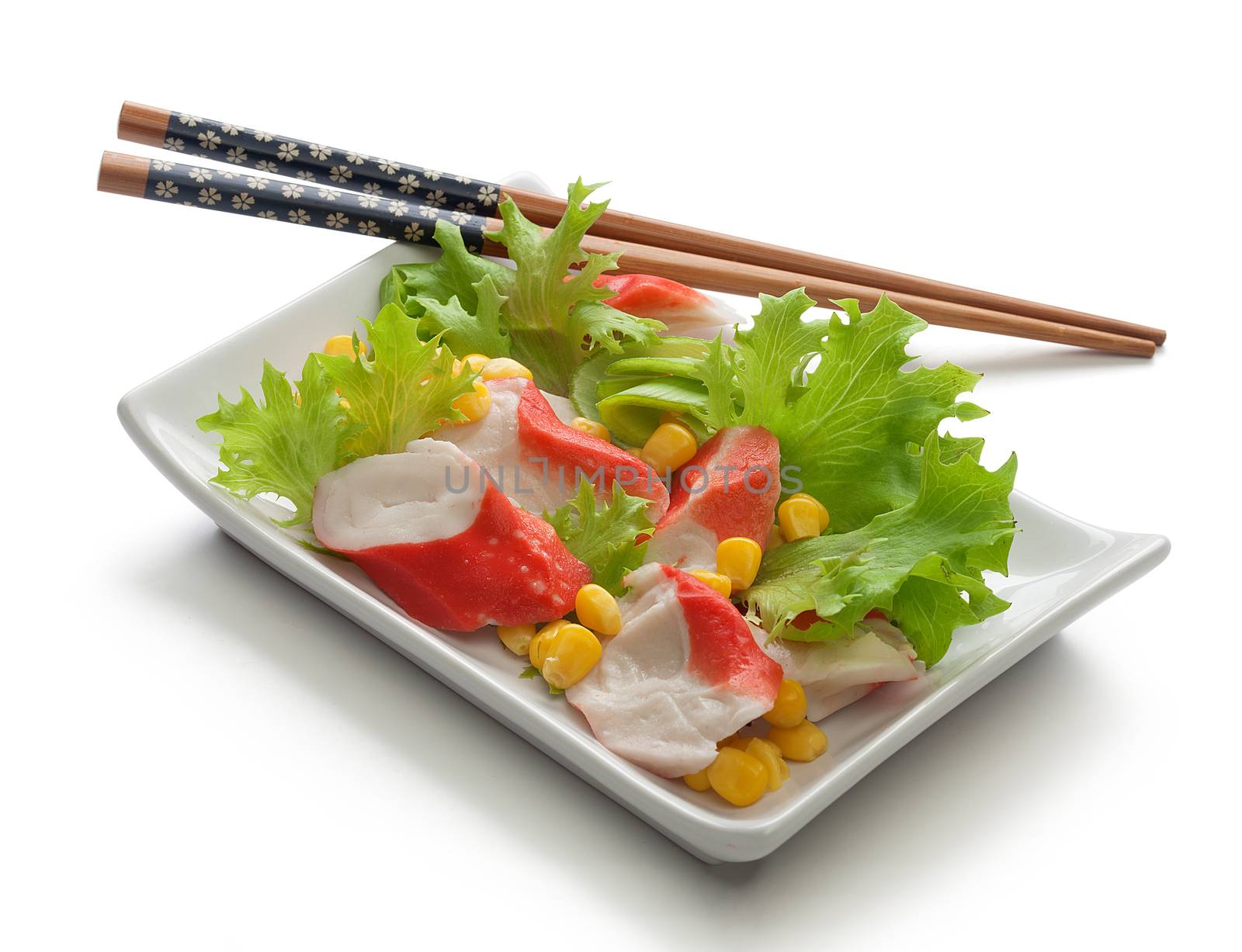 Crab meat with fresh green lettuce and corn's seeds on the plate