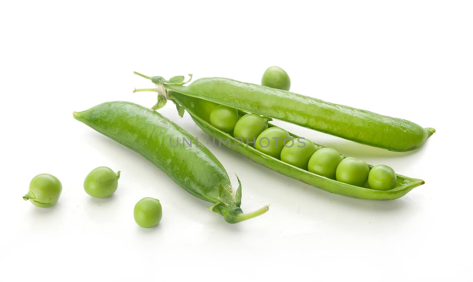 Isolated fresh green pea pods and peas on the white background