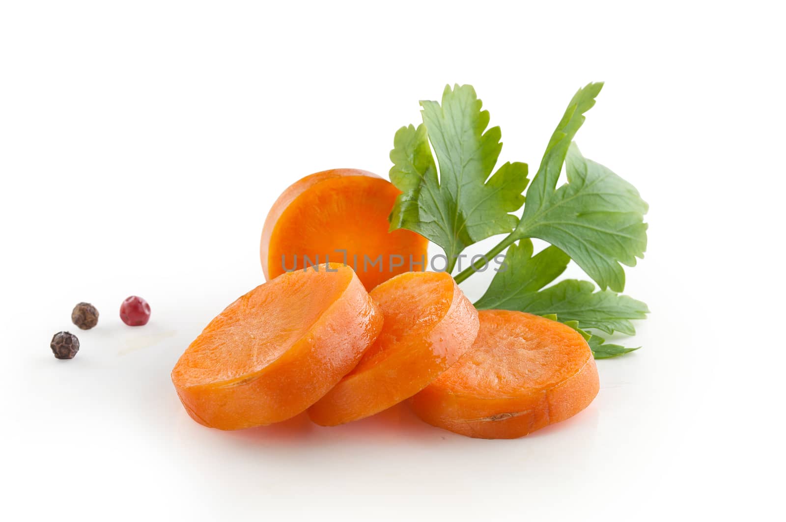 Hanfdul of orange sliced carrot with a fresh green parsley and pepper
