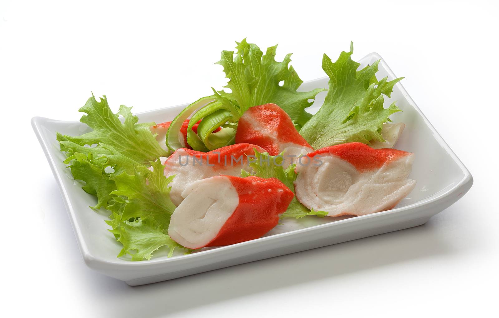 Crab meat with fresh green lettuce on the plate