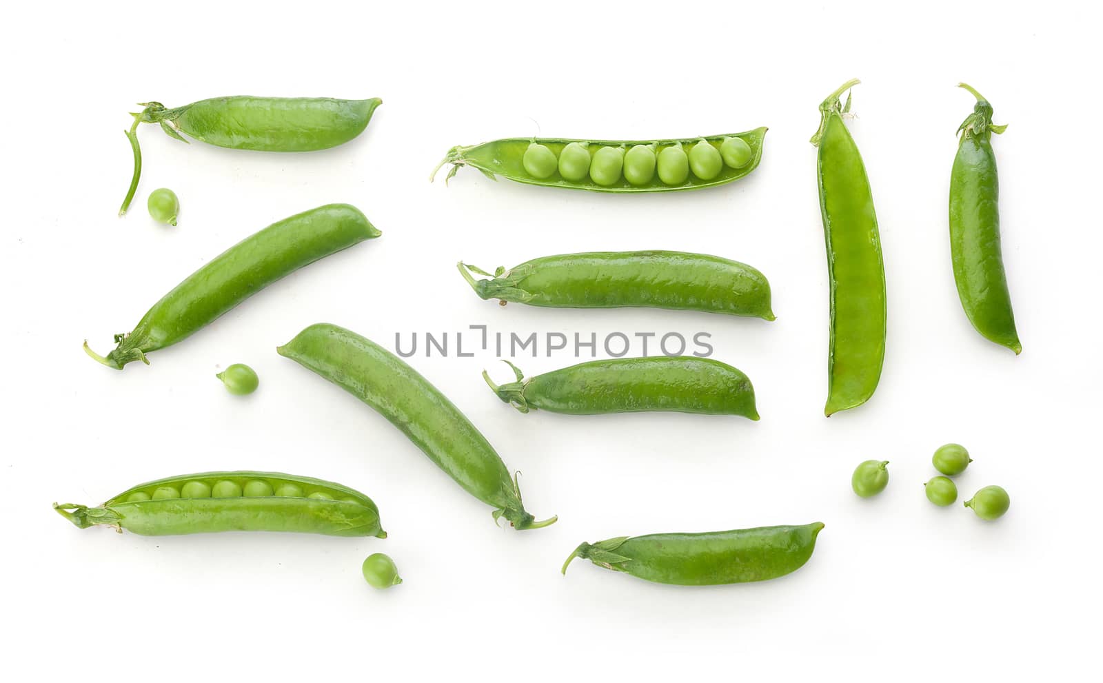 To view of fresh green pea pods and peas on the white background