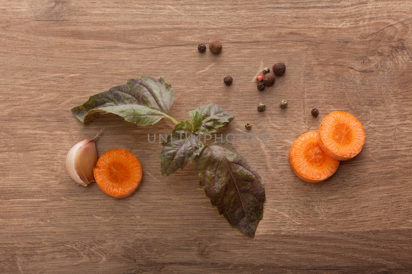 Slices of carrot, leaves of basil, clove of garlic and black pep by Angorius