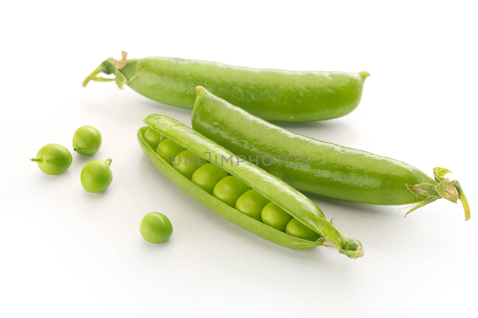 Isolated fresh green pea pods and peas on the white background