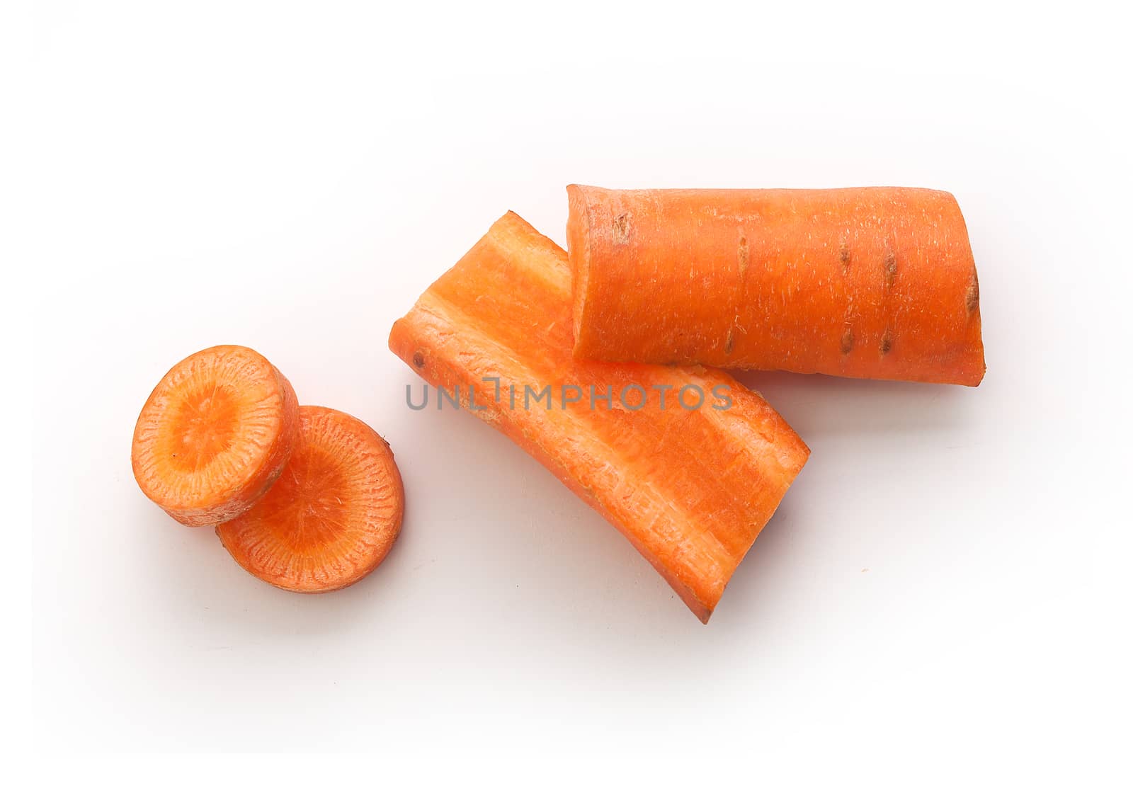 Top view of pieces and slices of carrot on the white background