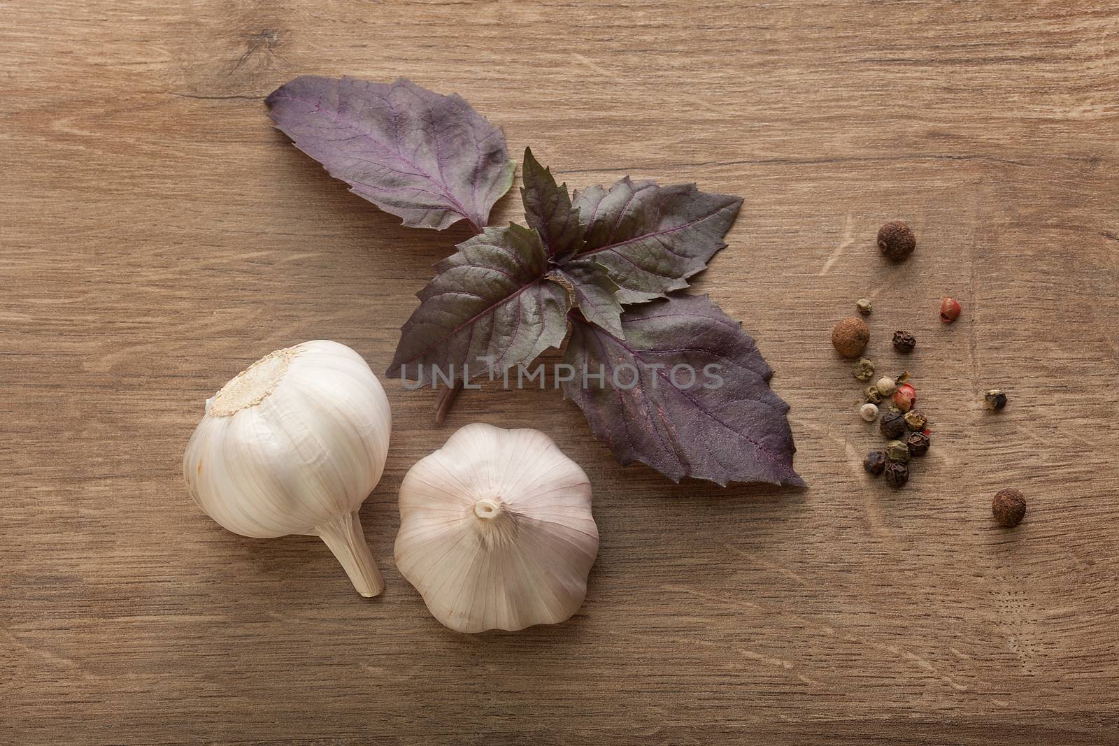 Garlic, basil and peppers on the wooden table by Angorius