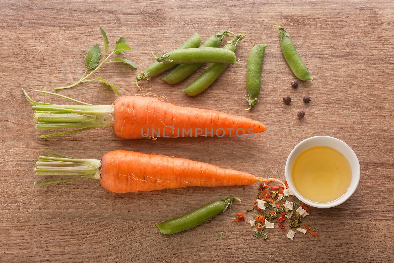 Carrot, peas and oil on the wood by Angorius