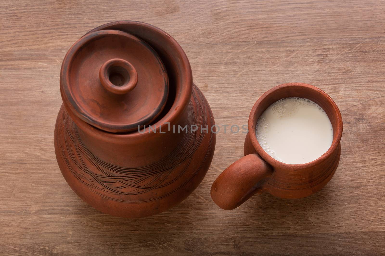 Clay jug and mug with milk by Angorius