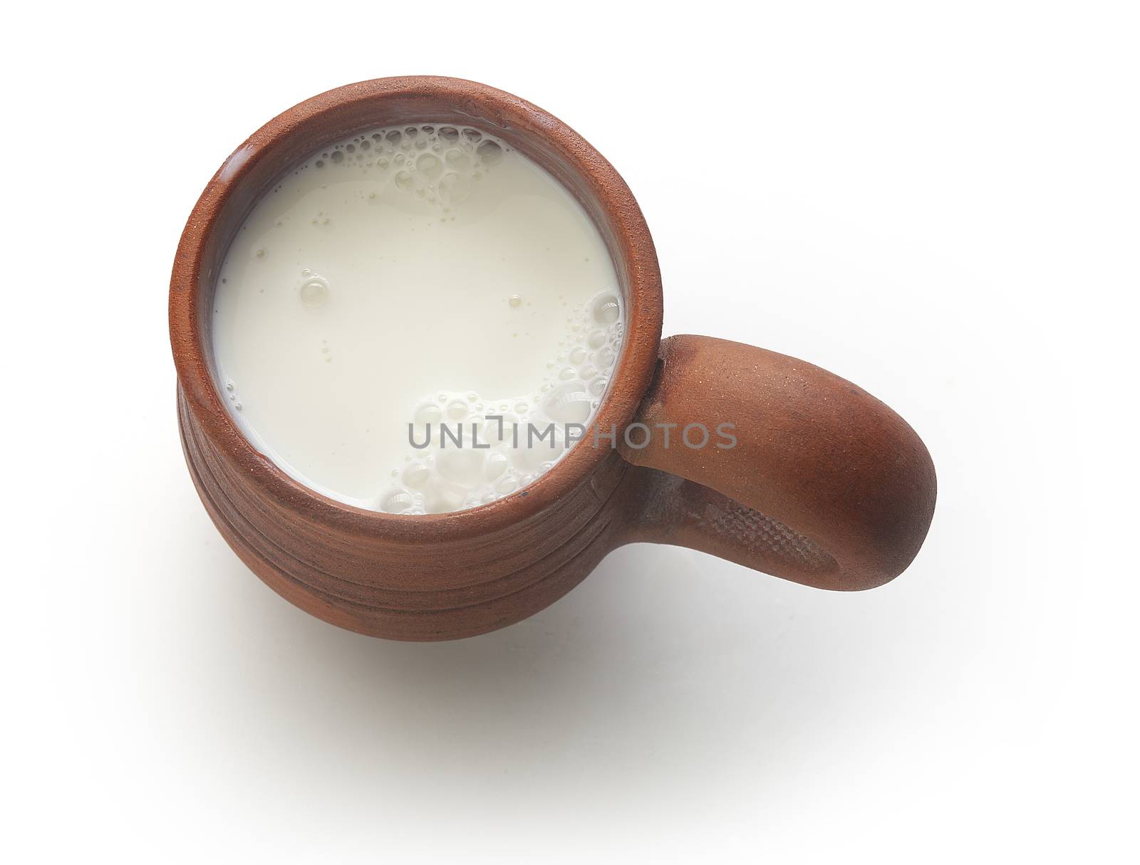 Top view of clay mug with milk