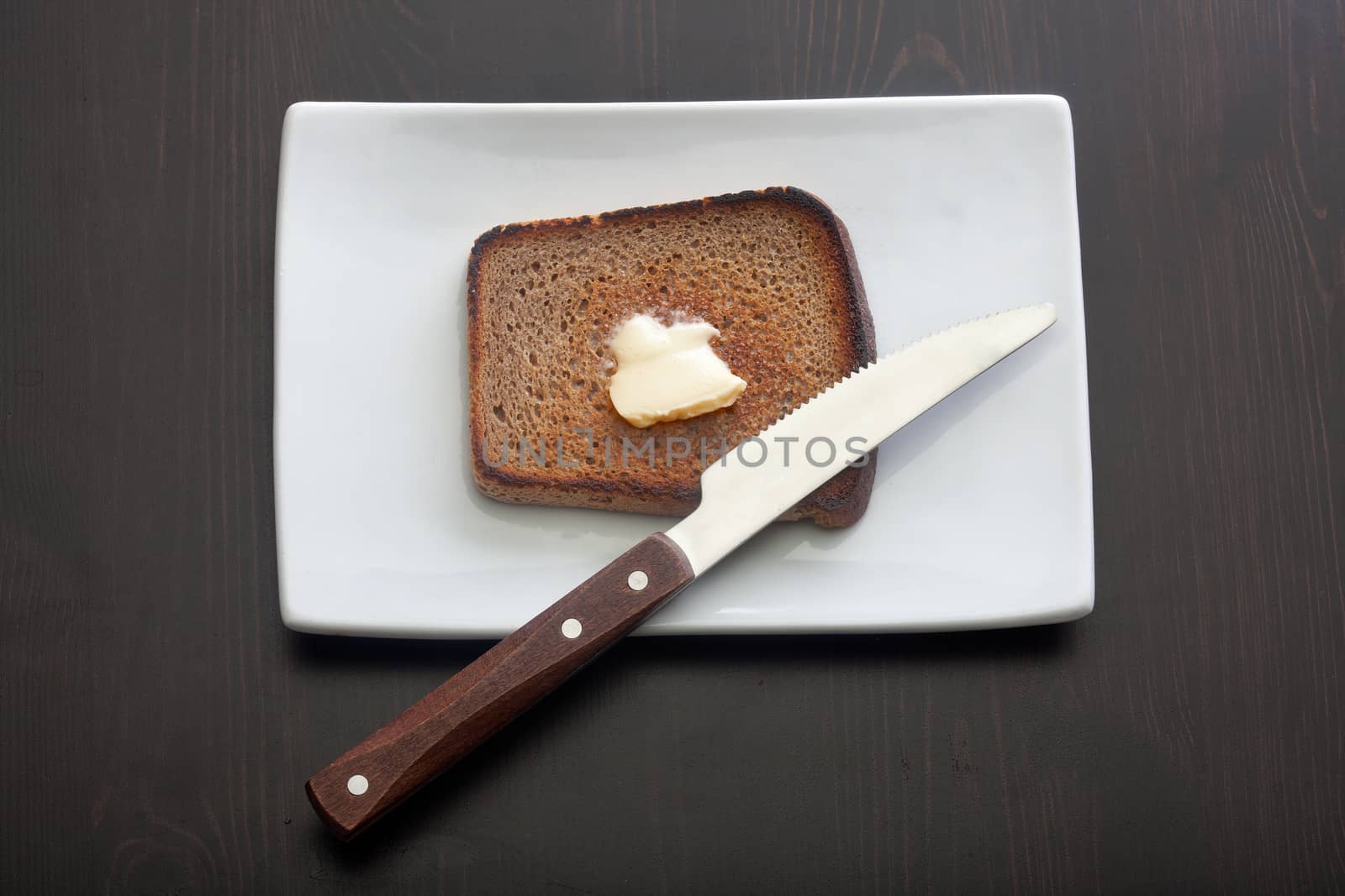 Toasted rye bread on the white plate by Angorius