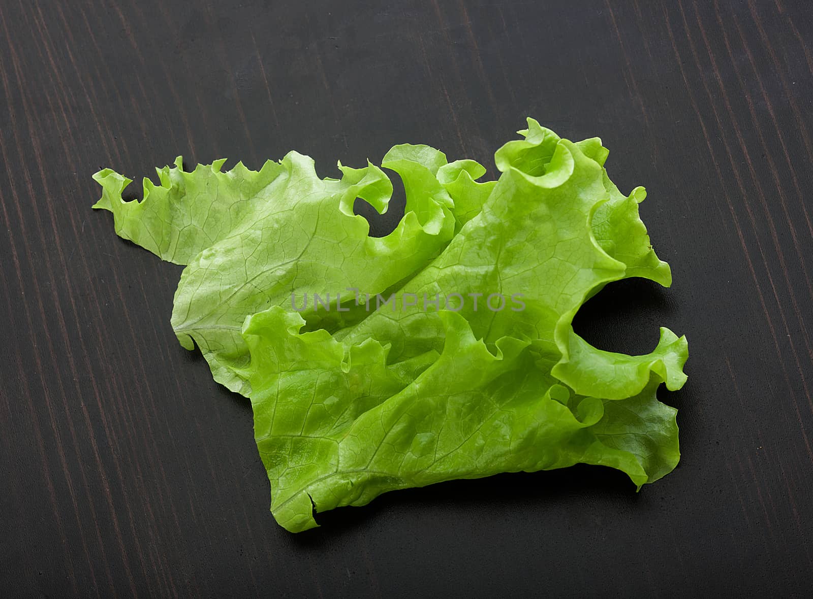 Top view of green fresh lettuce on the black wooden table