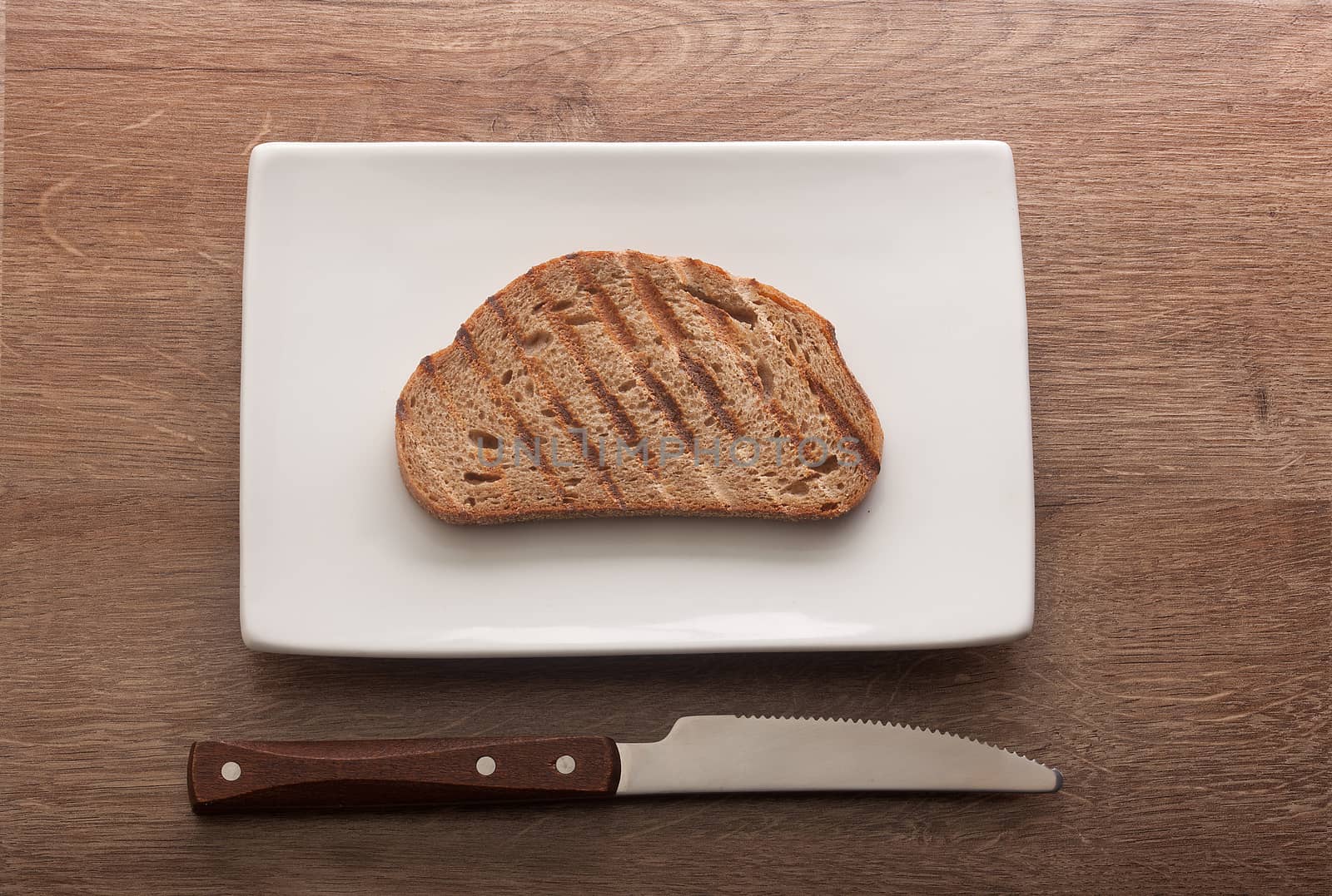 Top view of toasted rye bread on the white plate