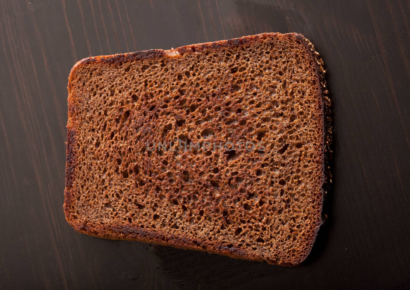 Toasted custard rye bread on the wooden table by Angorius