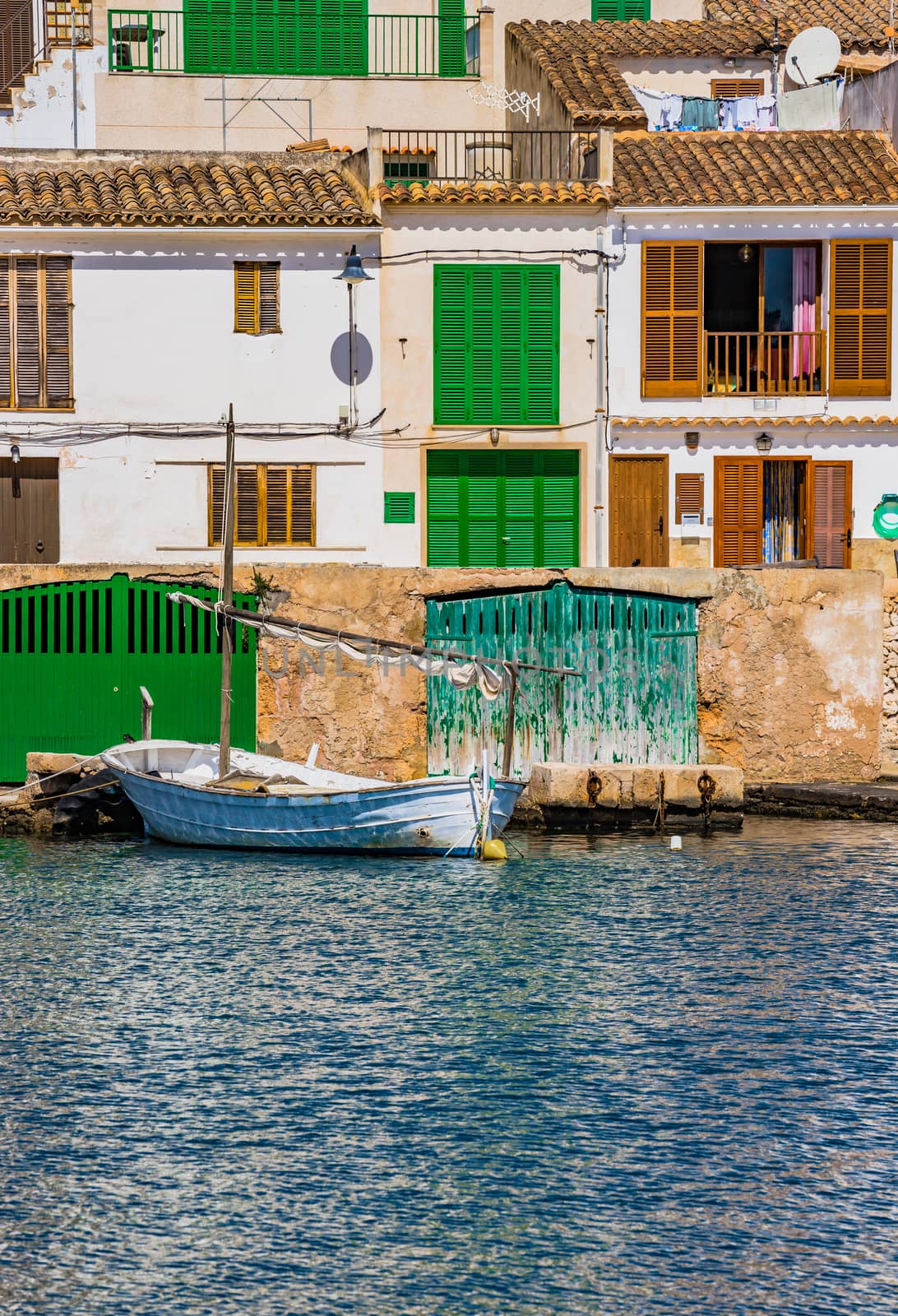 Beautiful view of old fishing boat anchored at the coast of mediterranean village on Mallorca, Spain