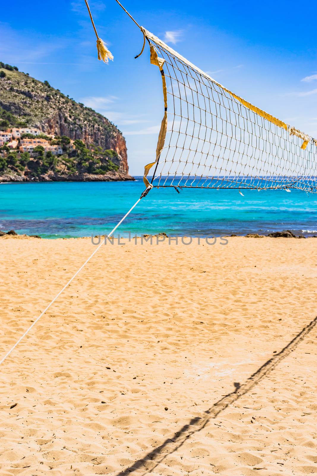 Sand beach volleyball net at beautiful seaside coast of Mallorca island, Spain
