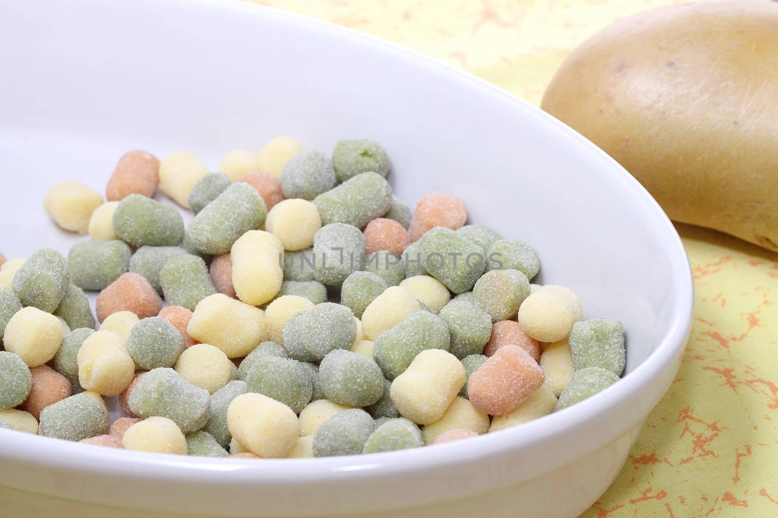 Italian gnocchi with basil leaves and potato