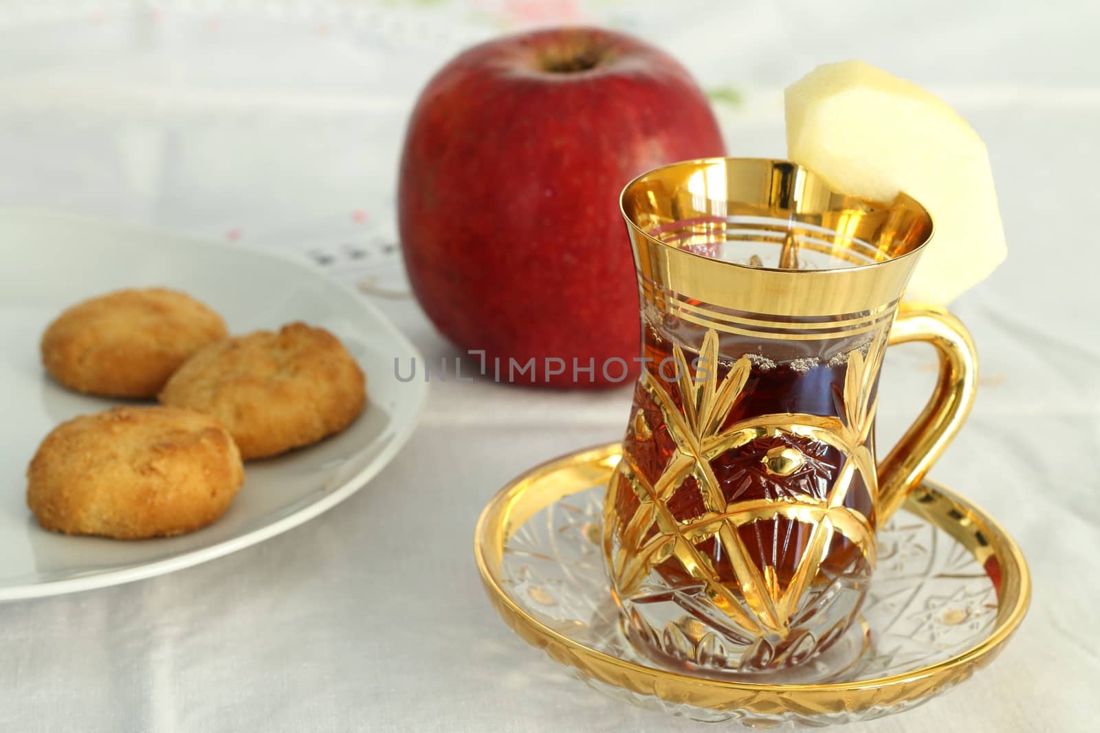 Cup of apple tea with biscuits