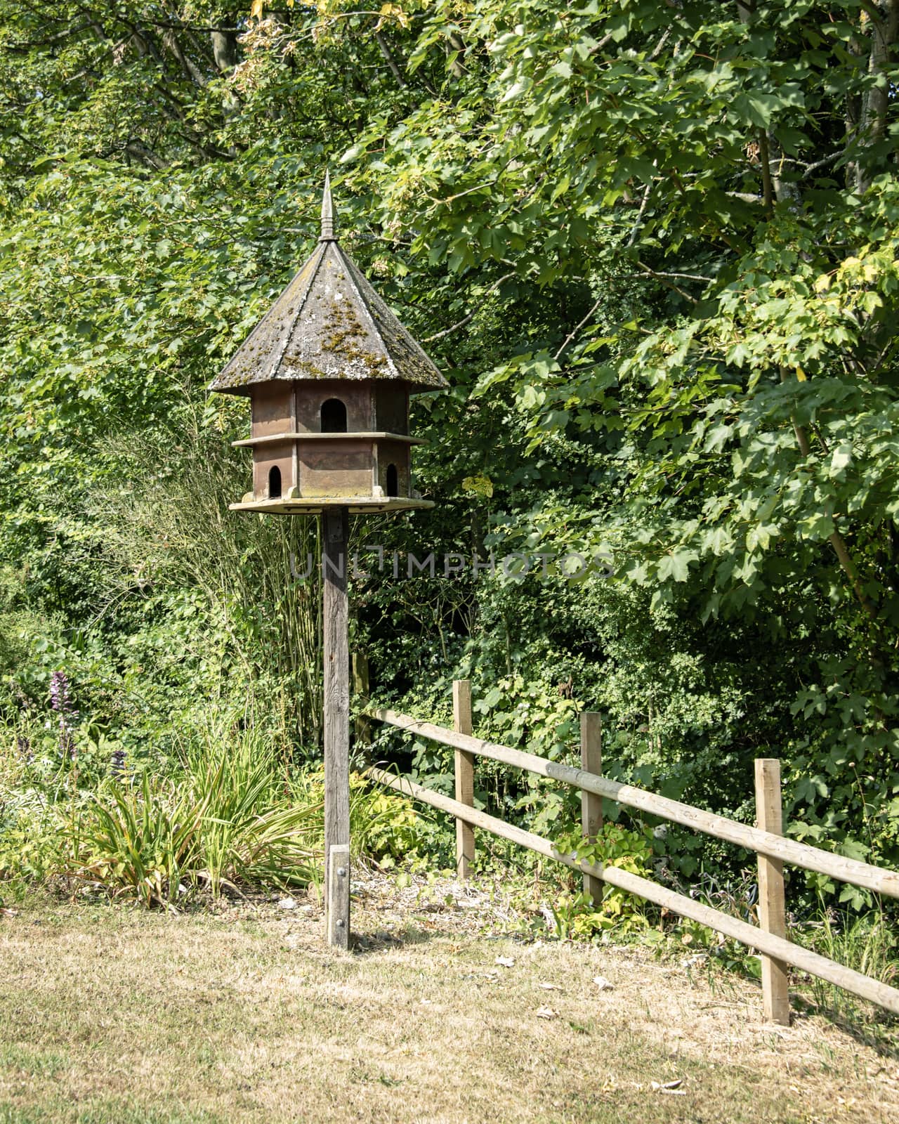UK, Launde Abbey, Leicestershire - July 2018: Large wooden dove cote in the afternoon s