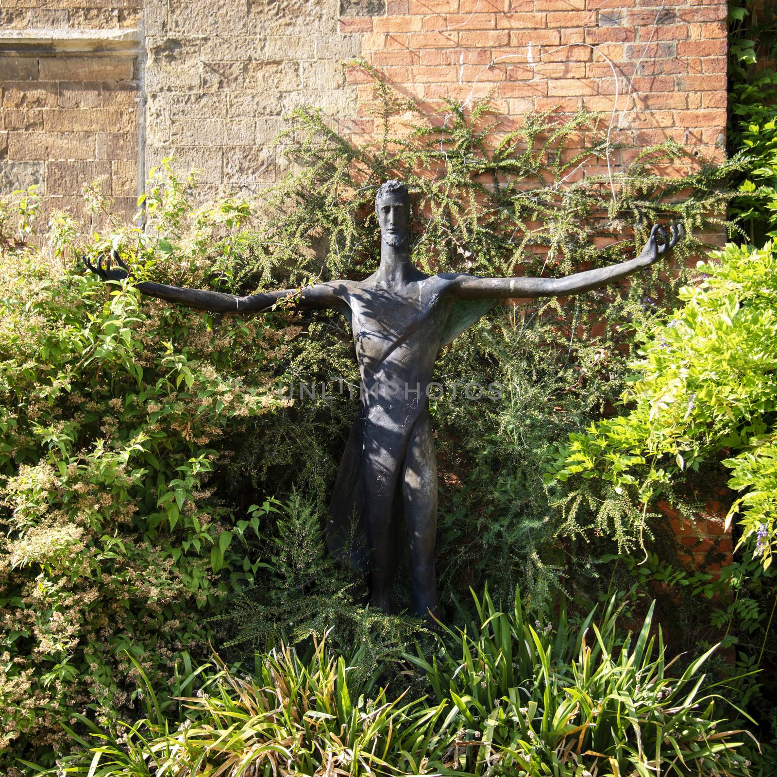 UK, Launde Abbey, Leicestershire - July 2018: Modern Statue of Christ in the abbey garden	