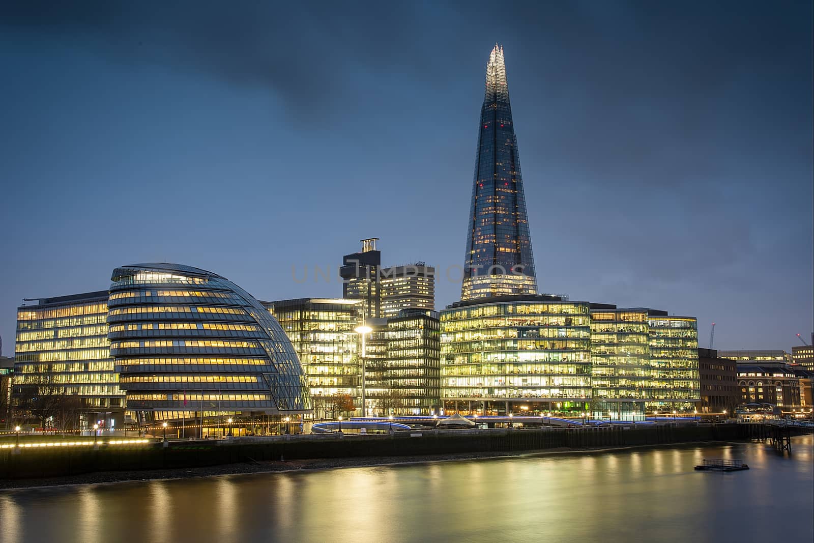 London, UK - Jan 2020: View over the Thames as night falls, taking in The Scoop, The Shard and City Hall