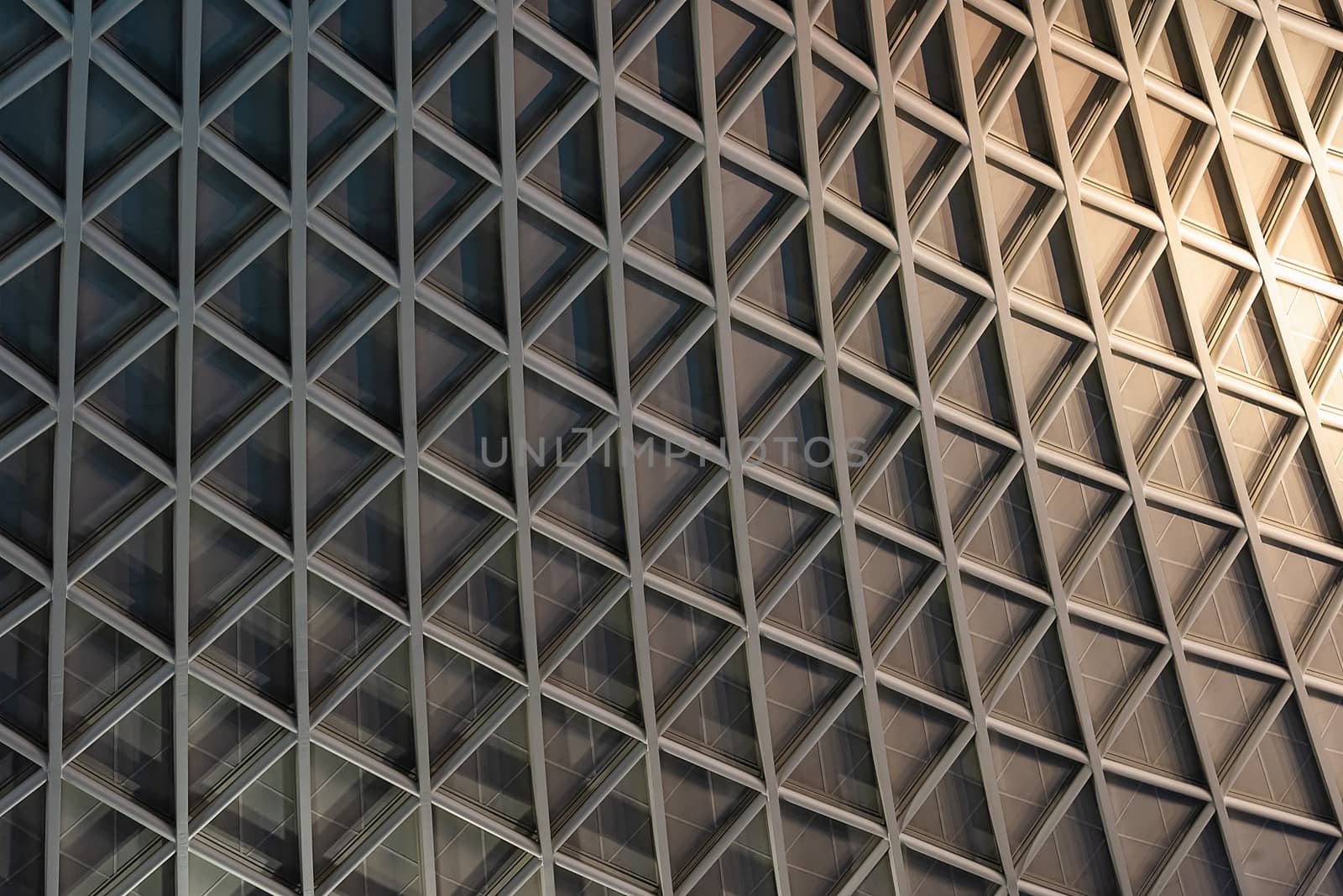 London, UK - Jan 2020:  The contemporary lattice ceiling of King's Cross railway station concourse, designed by John McAslan and partners. King's Cross station is a major transport hub.