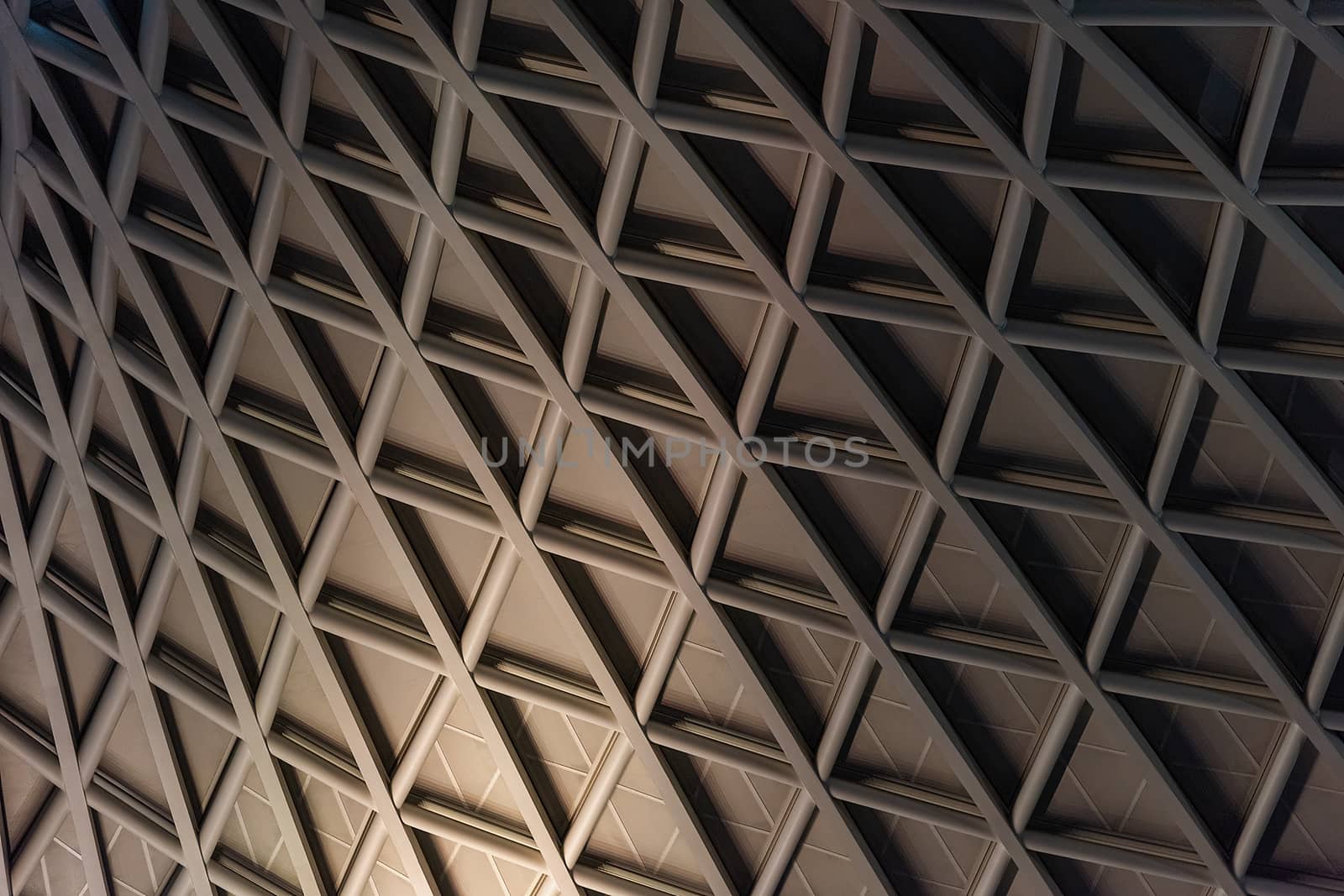 London, UK - Jan 2020:  The contemporary lattice ceiling of King's Cross railway station concourse, designed by John McAslan and partners. King's Cross station is a major transport hub.