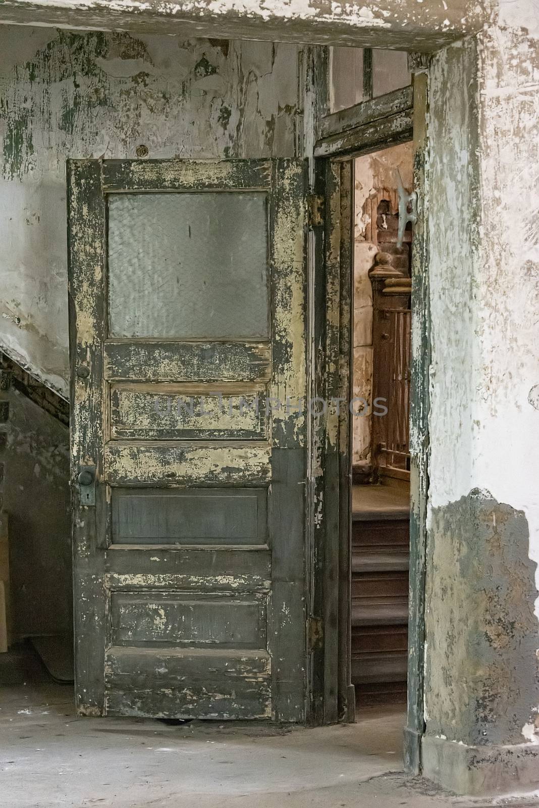 USA, New York, Ellis Island - May 2019: Pin flaking off an old interior door in an abandoned building