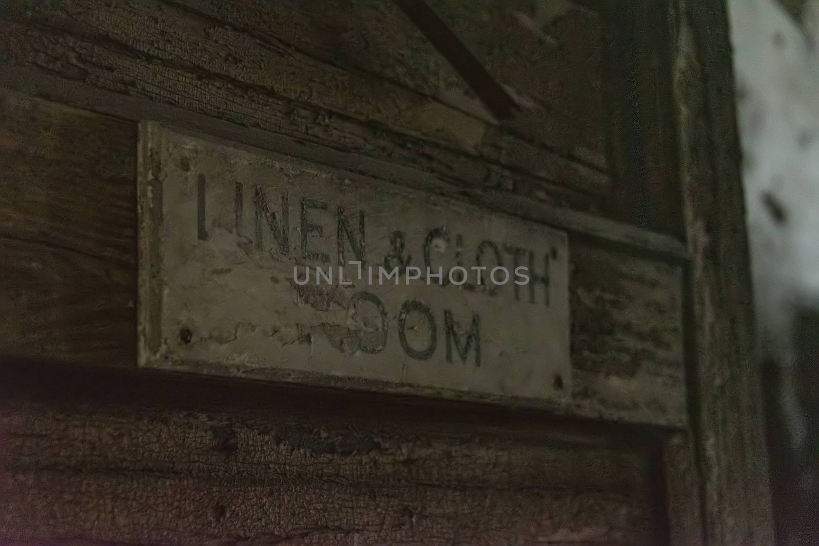 USA, New York, Ellis Island - May 2019: Decaying sign - Linen and cloth room' in an abandoned hospital