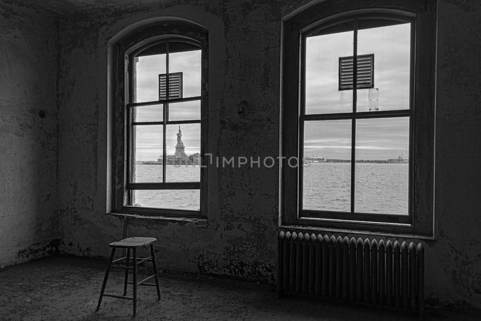 USA, New York, Ellis Island - May 2019: View of the Statue of Liberty through the window of the Contagious Diseases ward at Ellis Island Hospital