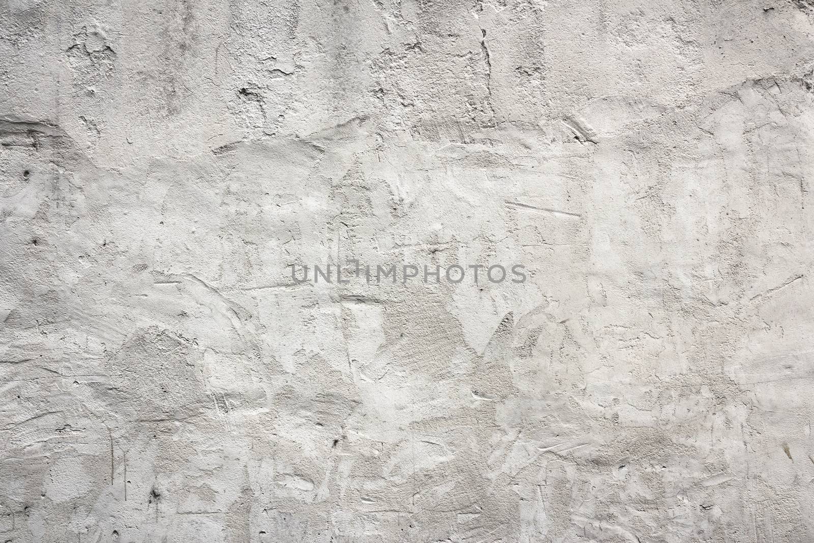 Old white concrete wall with plaster, grungy background.